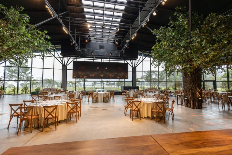 Spacious and elegant restaurant interior with large glass windows and modern decor.